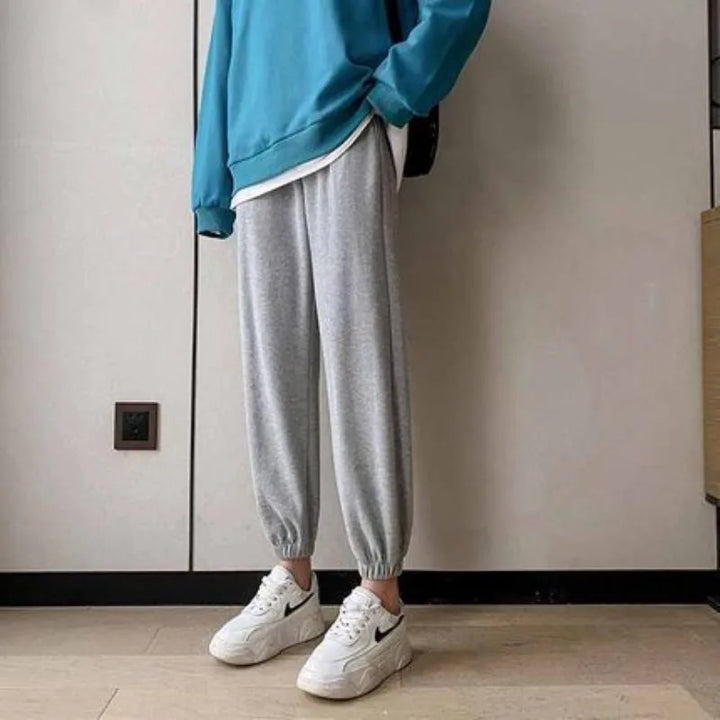 Casual winter fleece pants in gray, paired with a blue sweatshirt and white sneakers, perfect for chilly days.