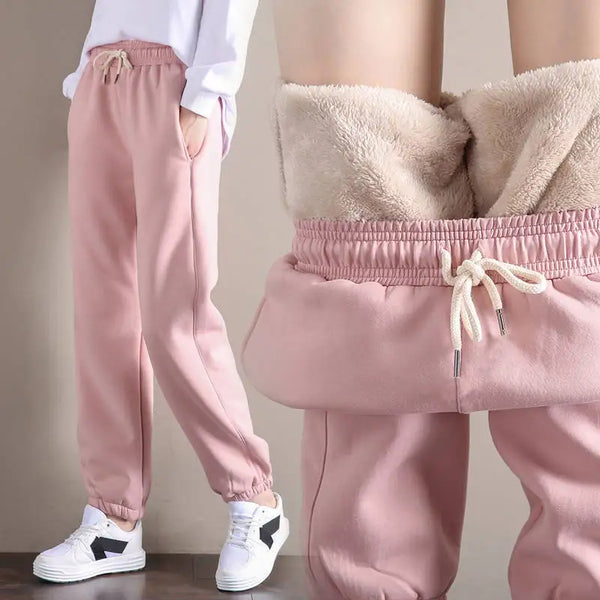 Comfortable winter fleece pants in pink, featuring a soft inner lining and elastic waistband, perfect for cold weather.