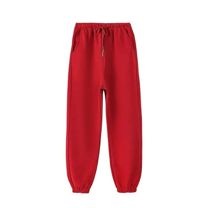 Red winter fleece pants with elastic waistband and pockets for comfort and warmth.